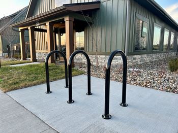 A row of bike racks in front of a building